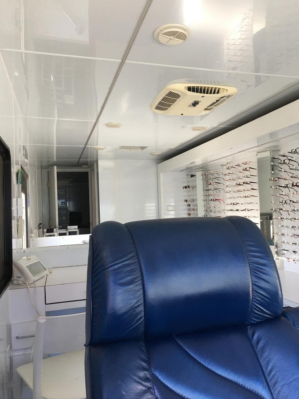Interior of the mobile clinic with exam chair and frame displays